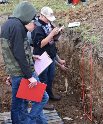 Students evaluating a soil pit during the 2022 SW WI Land Judging Competition