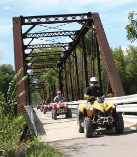 ATV's crossing bridge on trail